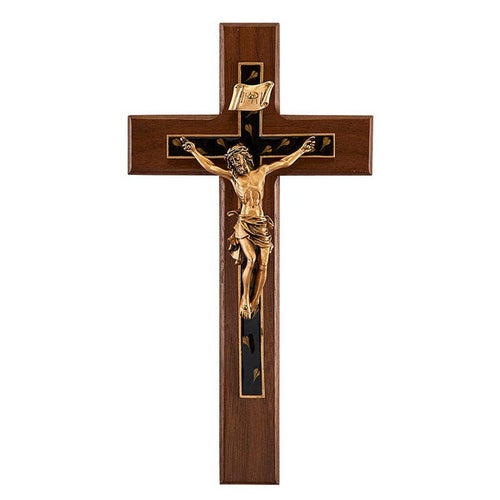 Wooden cross with gold Jesus figure on a white background