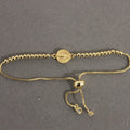 Gold bracelet on a gray background