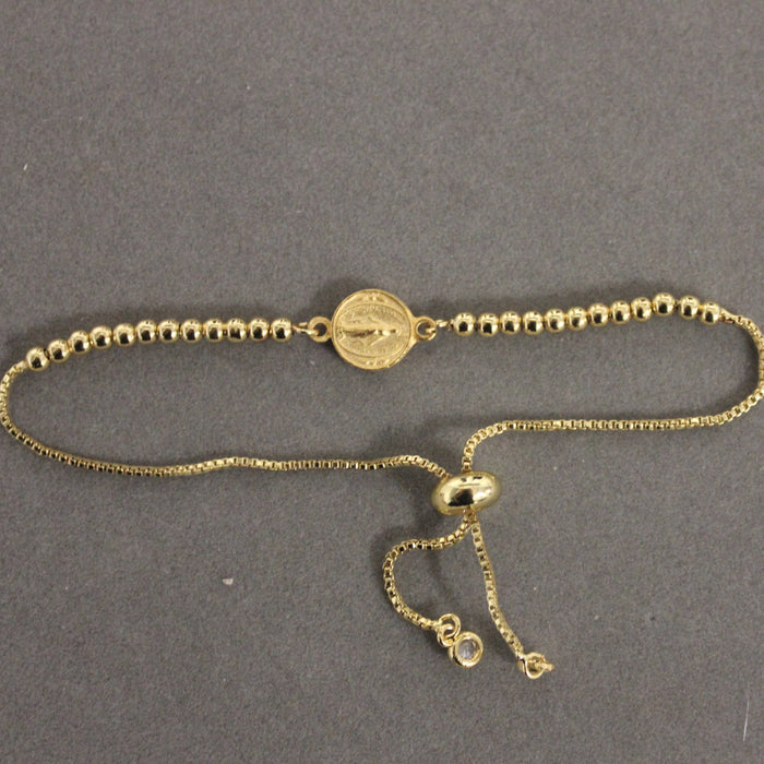 Gold bracelet on a gray background