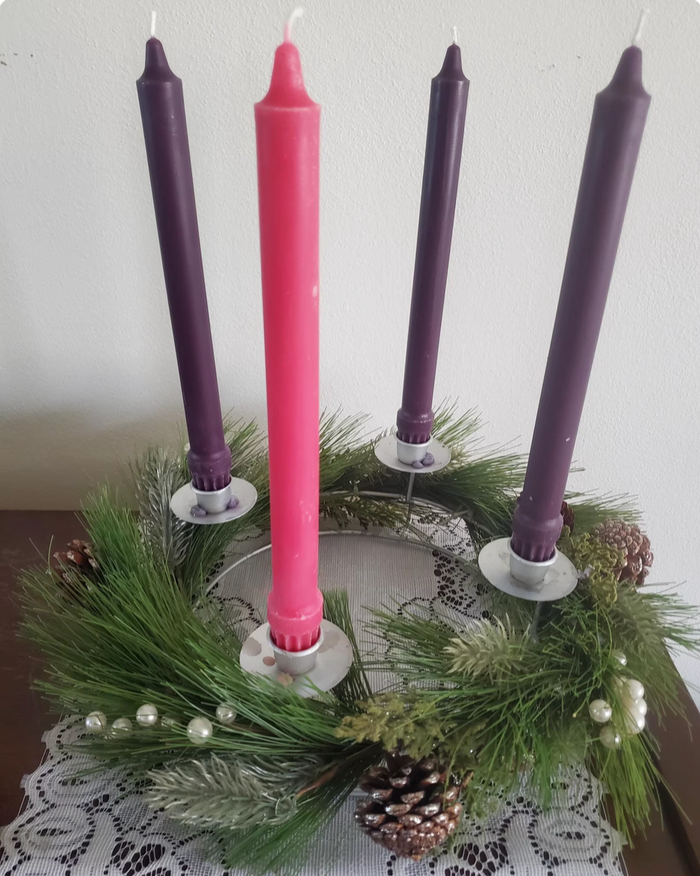 Advent candles with pine wreath on white background