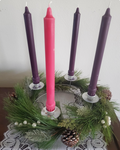 Advent candles with pine wreath on white background