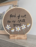 Brown embroidery with daisy flowers on a white and grey background