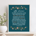 Be at peace with navy blue background and floral design framed on wood table by plant