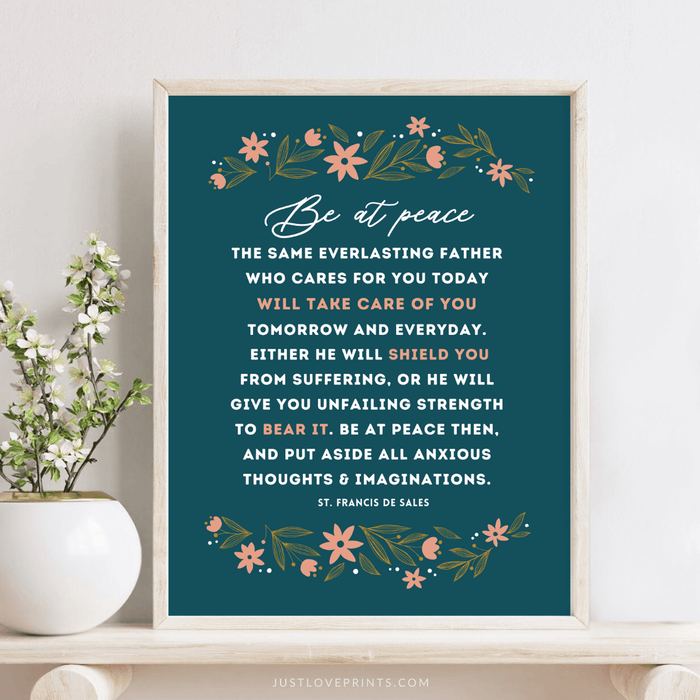 Be at peace with navy blue background and floral design framed on wood table by plant
