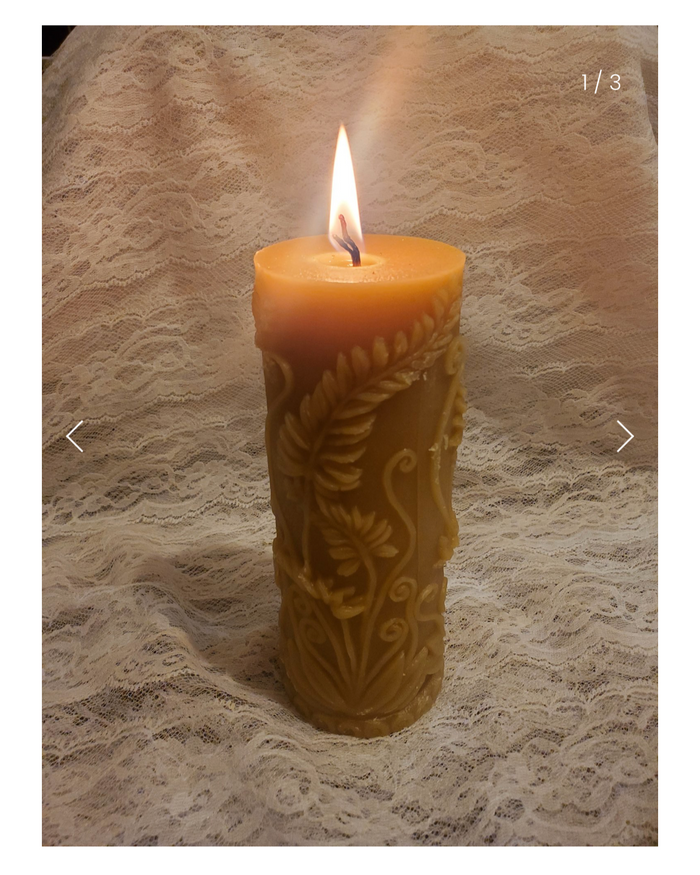 Beeswax fern candle on a textured surface