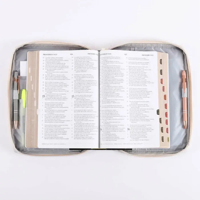 Open book inside a grey case with pens