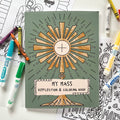 Coloring book titled 'My Mass Reflection & Coloring Book' with markers on a white surface