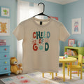 White tank top with colorful text design on a hanger against a home background.
