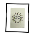 Framed artwork with decorative text and floral design on a light background