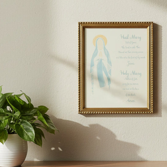 Framed artwork of Mary with text on a white surface