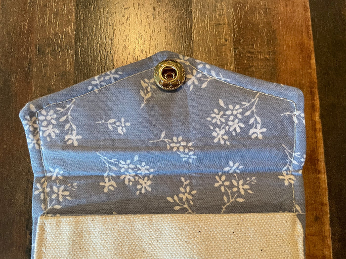 Floral-patterned fabric pouch on a wooden surface