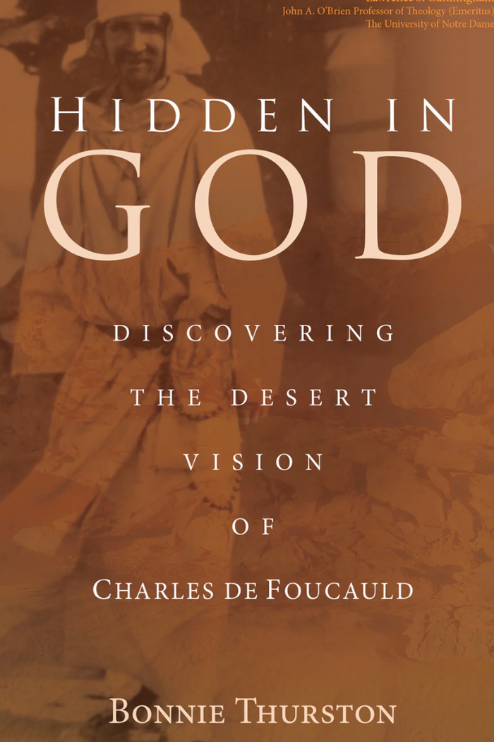 Book cover of 'Hidden in God' with a blurred background of people in robes.