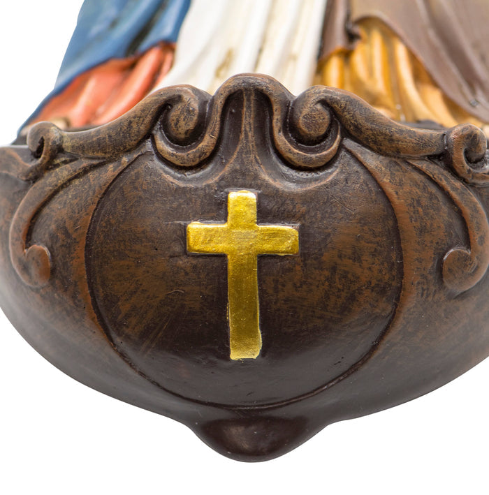 Close-up of a decorative object with a gold cross on a brown background