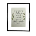 Framed print with religious text and leaves on a white fabric background