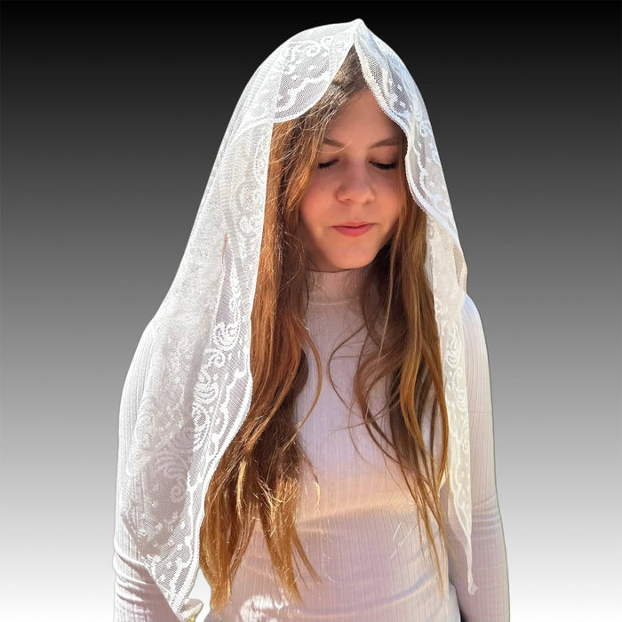 Woman wearing a white lace veil on a gradient background