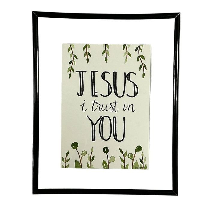 Framed print with 'Jesus I trust in You' text on a white shirt.