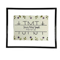 Framed artwork with 'Jesus, Mary & Joseph Pray for Us' text and floral design on a white background