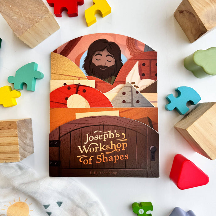 Children's book titled 'Joseph's Workshop of Shapes' surrounded by wooden shapes on a white background