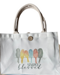 White tote bag with colorful birds and 'Simply Blessed' text on a white background