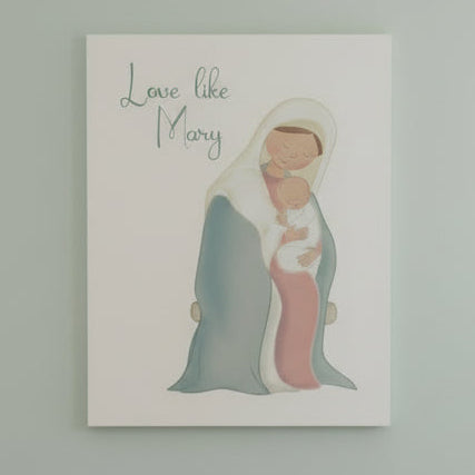 Print with illustration of Mary holding baby Jesus on a white surface