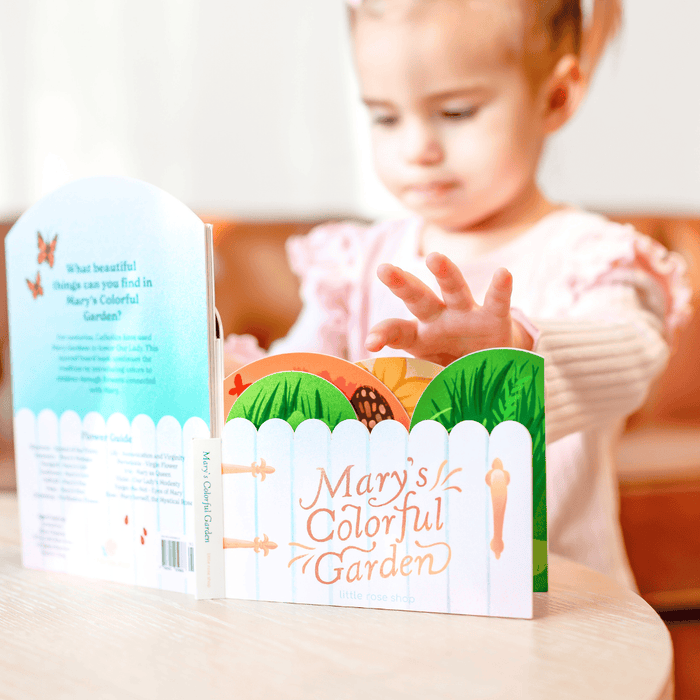 Child looking at a book titled 'Mary's Colorful Garden' with a focus on the cover design.