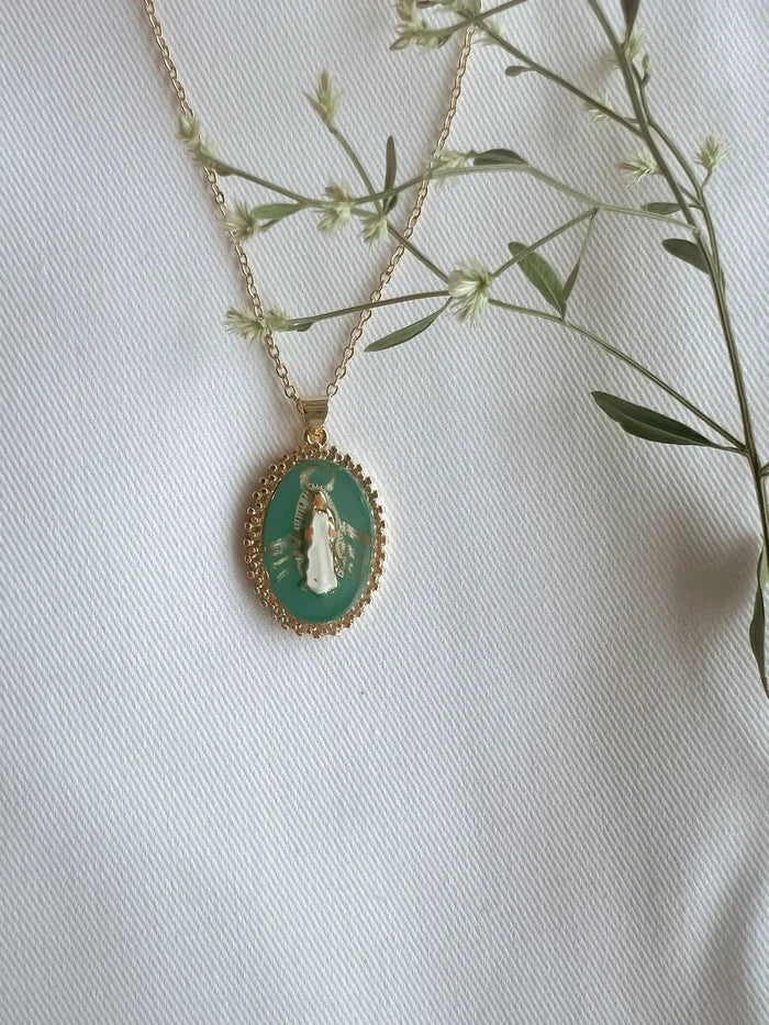 Necklace with a green pendant on a white background