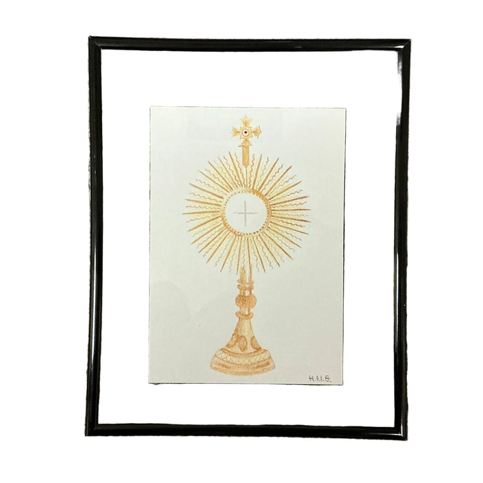 Framed artwork of a gold monstrance on a white background