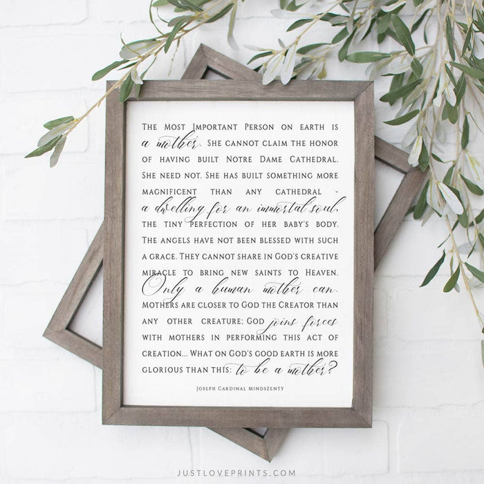 Framed print with a quote about mothers on a white background with greenery