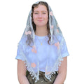 Person wearing a white embroidered veilwith floral patterns on a plain background