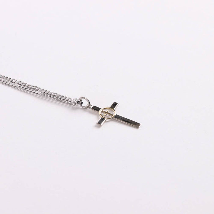 Silver chain necklace with a cross pendant on a white background