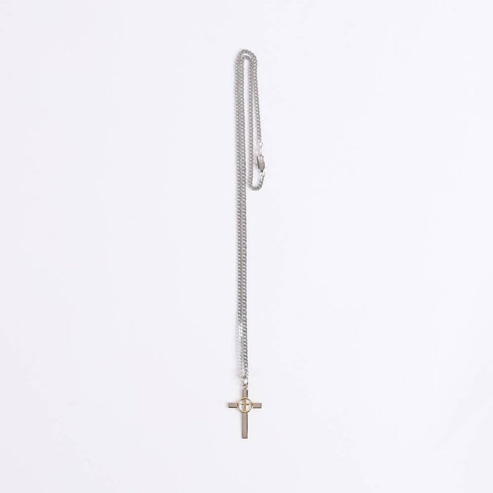 Silver necklace with a cross pendant on a light gray background