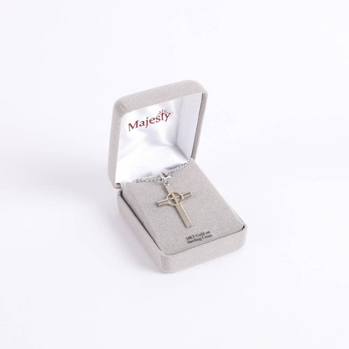 Silver cross necklace in a 'Majesty' jewelry box on a white background