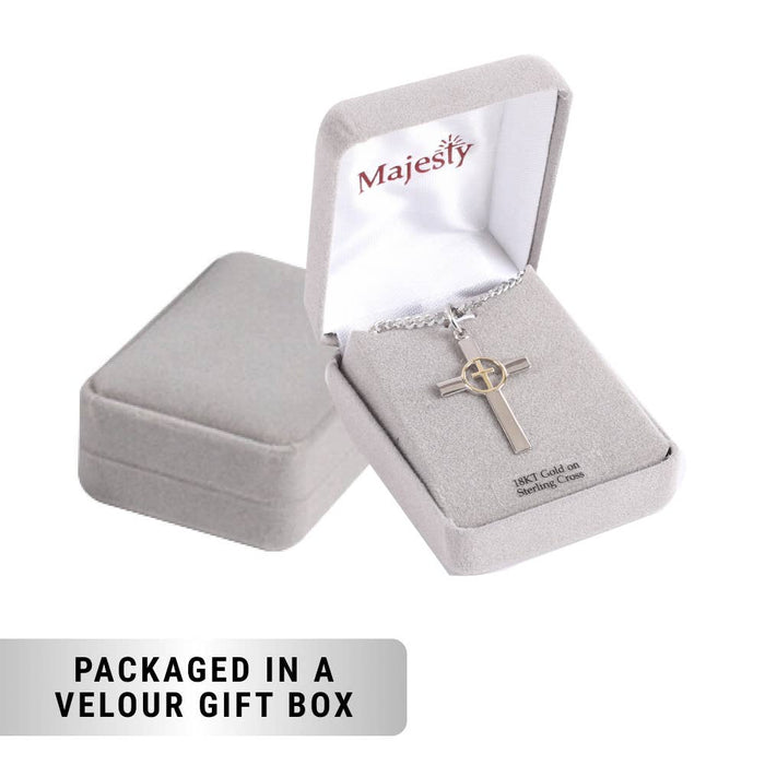Silver cross necklace in an open velour gift box with 'Majesty' branding.
