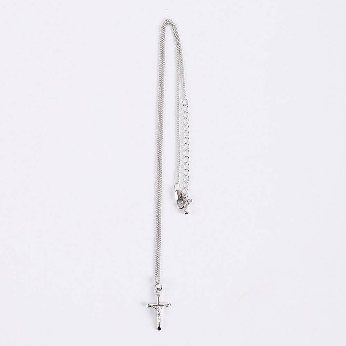 Silver necklace with a cross pendant on a white background