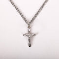 Silver crucifix necklace on a white background