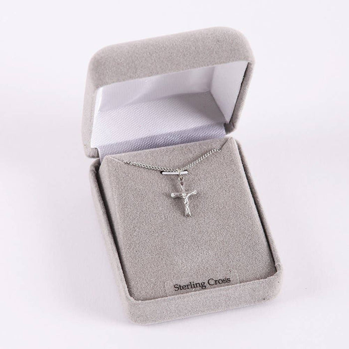 Silver cross necklace in a jewelry box with 'Sterling Cross' branding.
