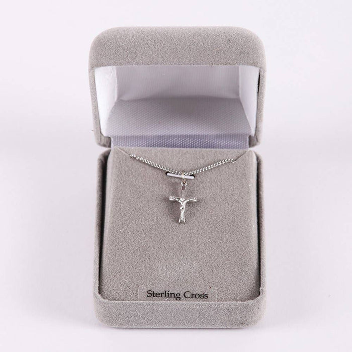 Silver crucifix necklace in a 'Sterling Cross' box on a white background