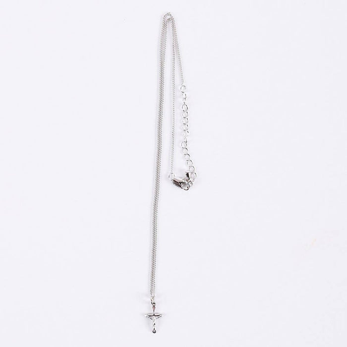 Silver necklace with a star pendant on a light gray background