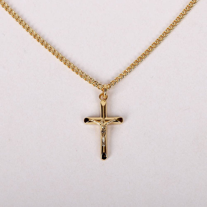 Gold cross necklace on a white background