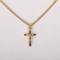 Gold cross necklace on a white background
