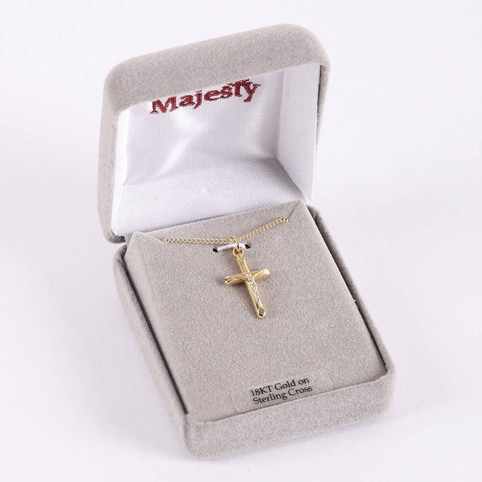 Gold cross necklace in a 'Majesty' branded jewelry box on a white background