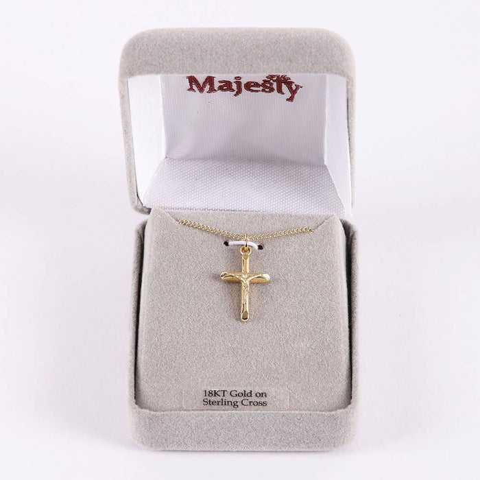 Gold cross necklace in a 'Majesty' jewelry box on a white background
