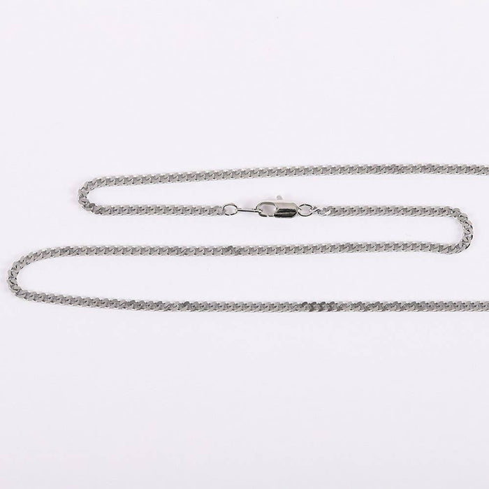 Silver chain necklace on a light gray background