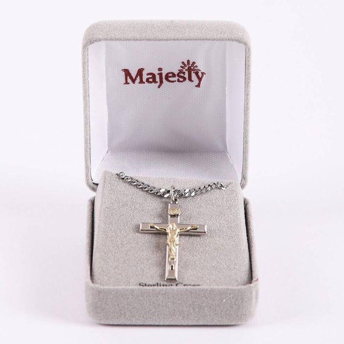 Silver cross necklace in a Majesty branded box on a white background