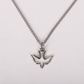Silver dove pendant necklace on a light gray background