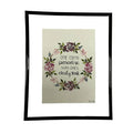 Framed artwork with floral design and text on a beige background