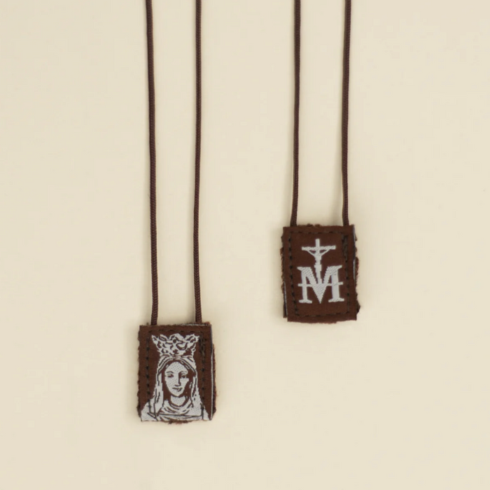 Our Lady of Mount Carmel scapular on a beige background