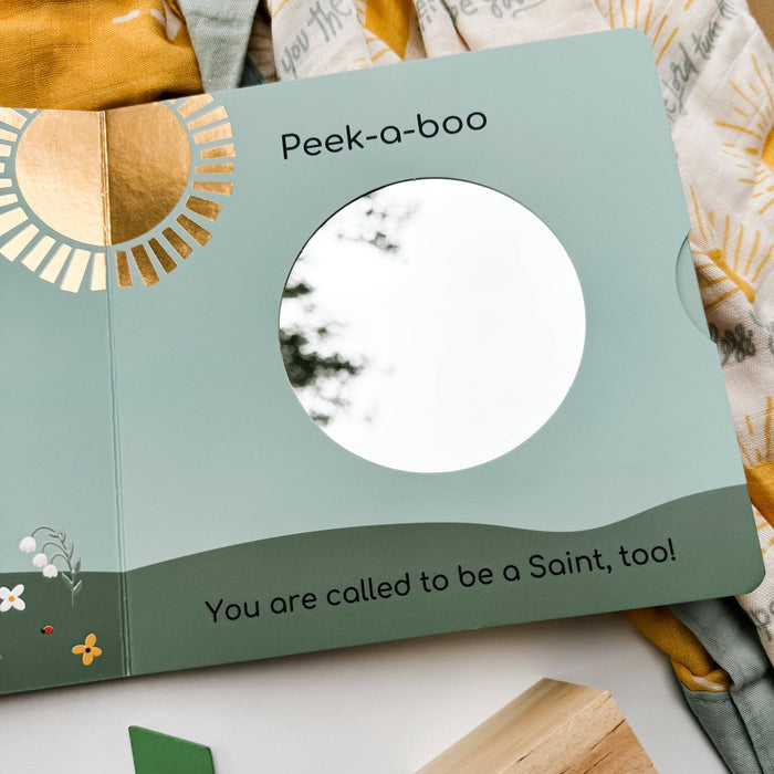 Children's book with a peek-a-boo window and text on a soft fabric background