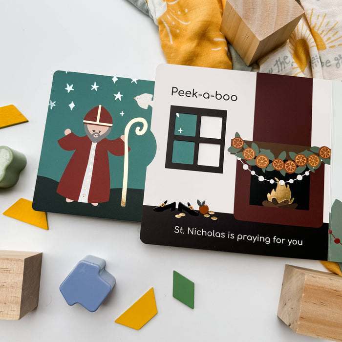 Children's book with St. Nicholas design on a white surface with toys around