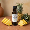 Pineapple White Balsamic Vinegar bottle with fresh pineapple on terracotta surface